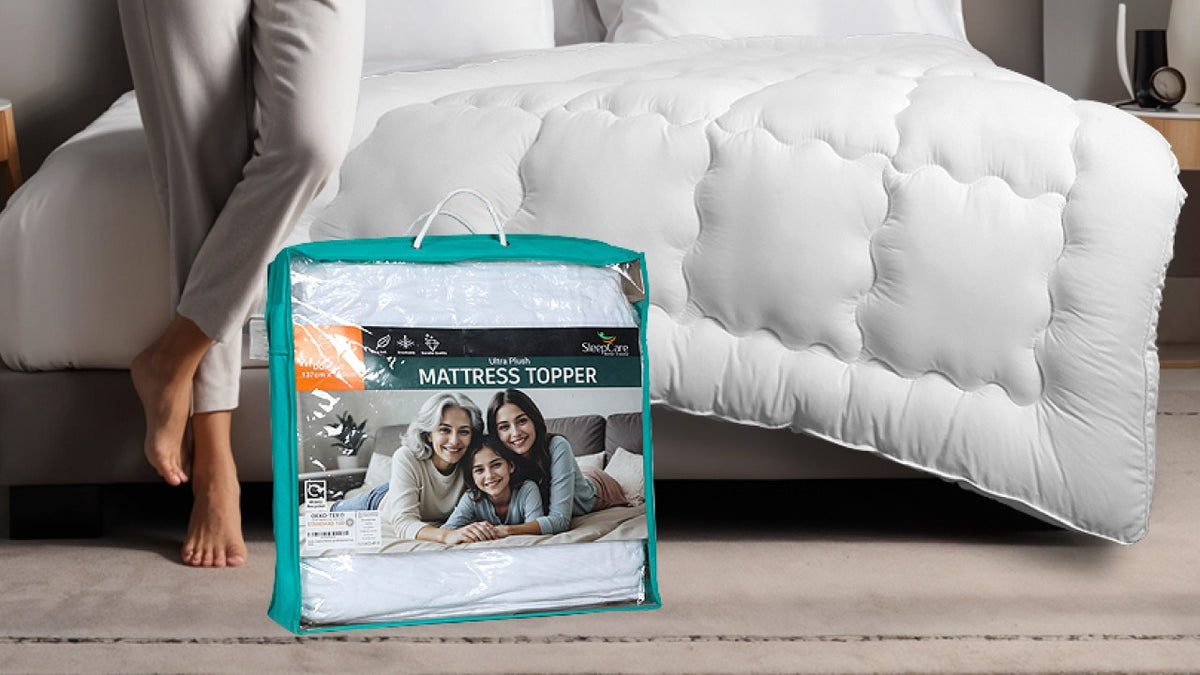 Mattress topper packaging with a family photo Infront of a bed  with a white mattress topper